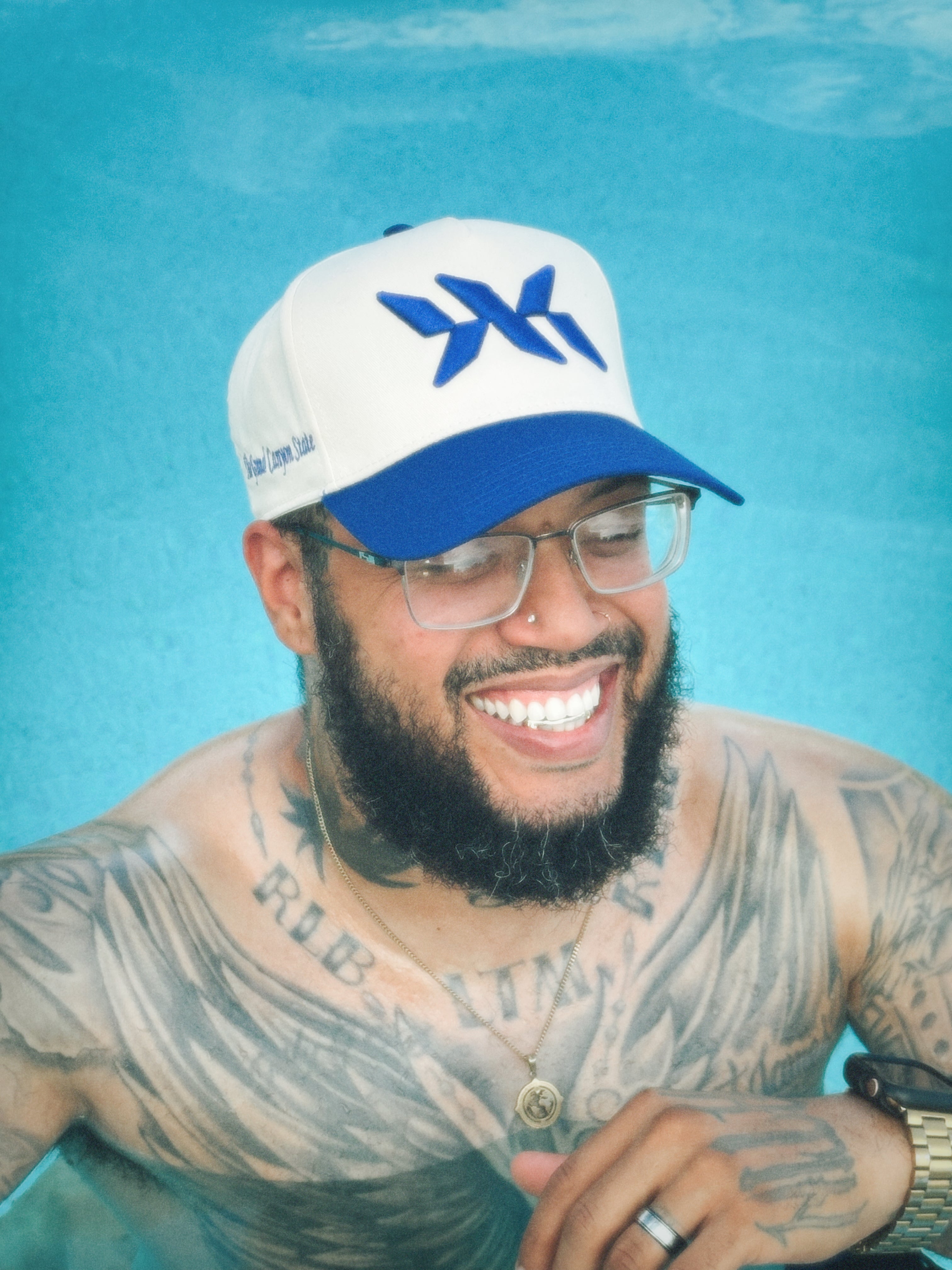 Model wearing cream and royal blue DNA Strand snapback by IAC Lyfestyle