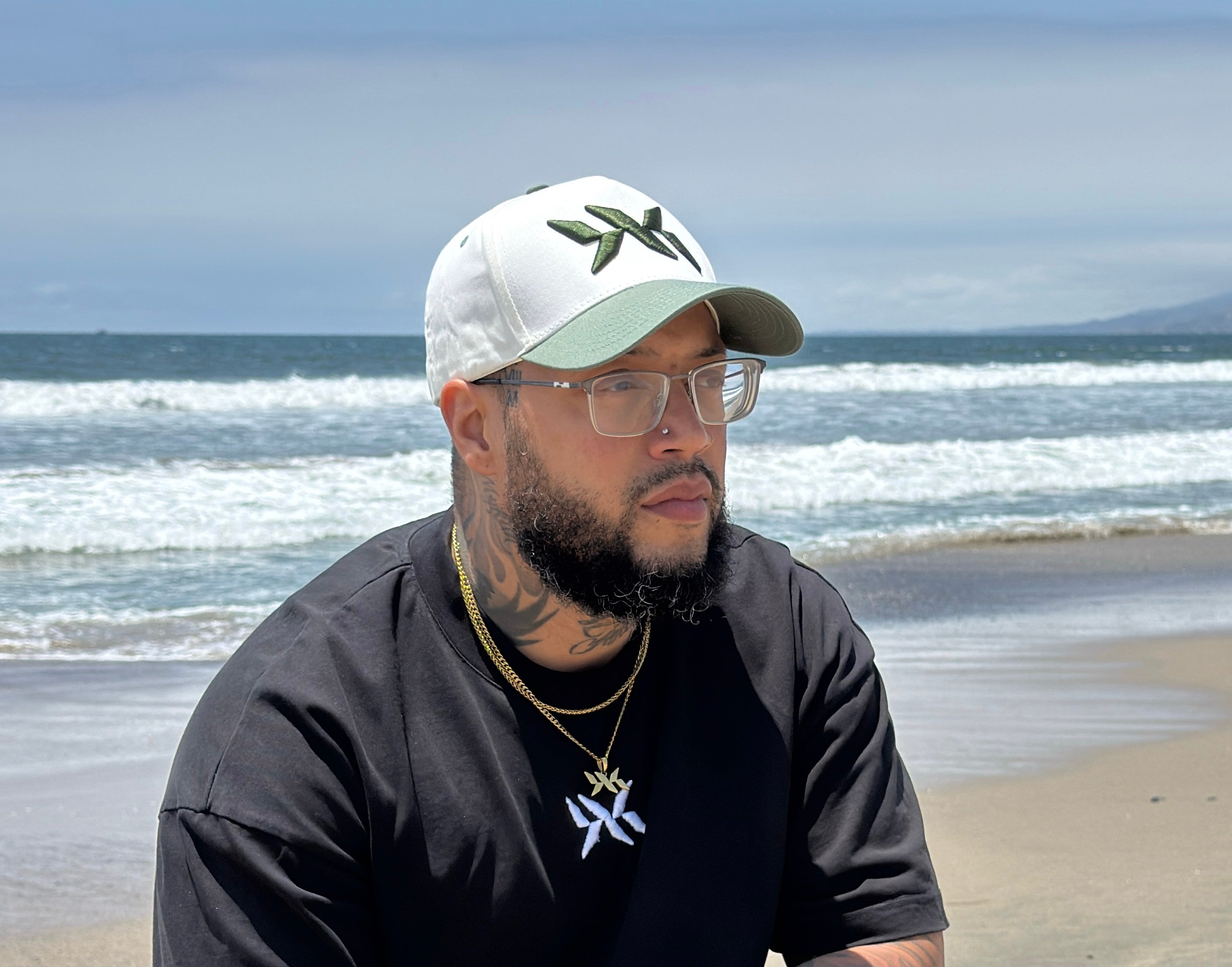 DNA Strand snapback hat worn outdoors, highlighting fit and style from the IAC Lyfestyle snapback bundle. Ocean in the background
