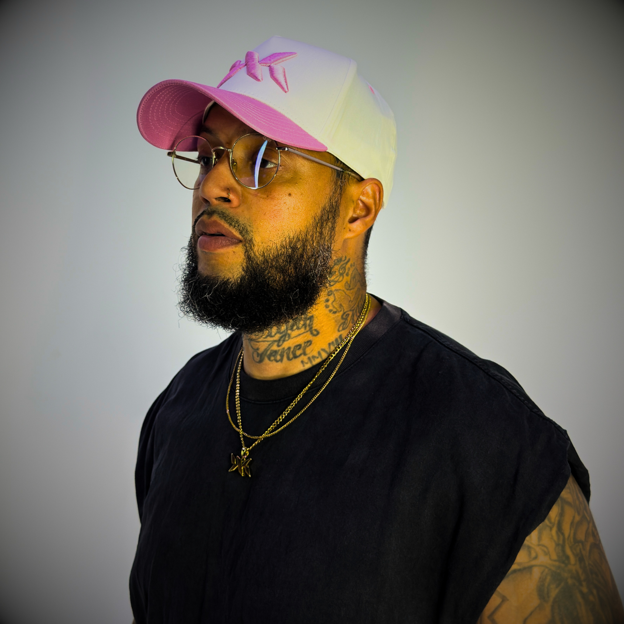 Model wearing a pink and cream DNA Strand snapback hat from the IAC Lyfestyle snapback bundle.