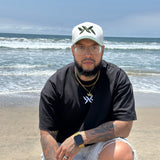 Model wearing IAC Lyfestyle DNA Strand snapback and tee at the beach, part of the DNA Core Duo bundle