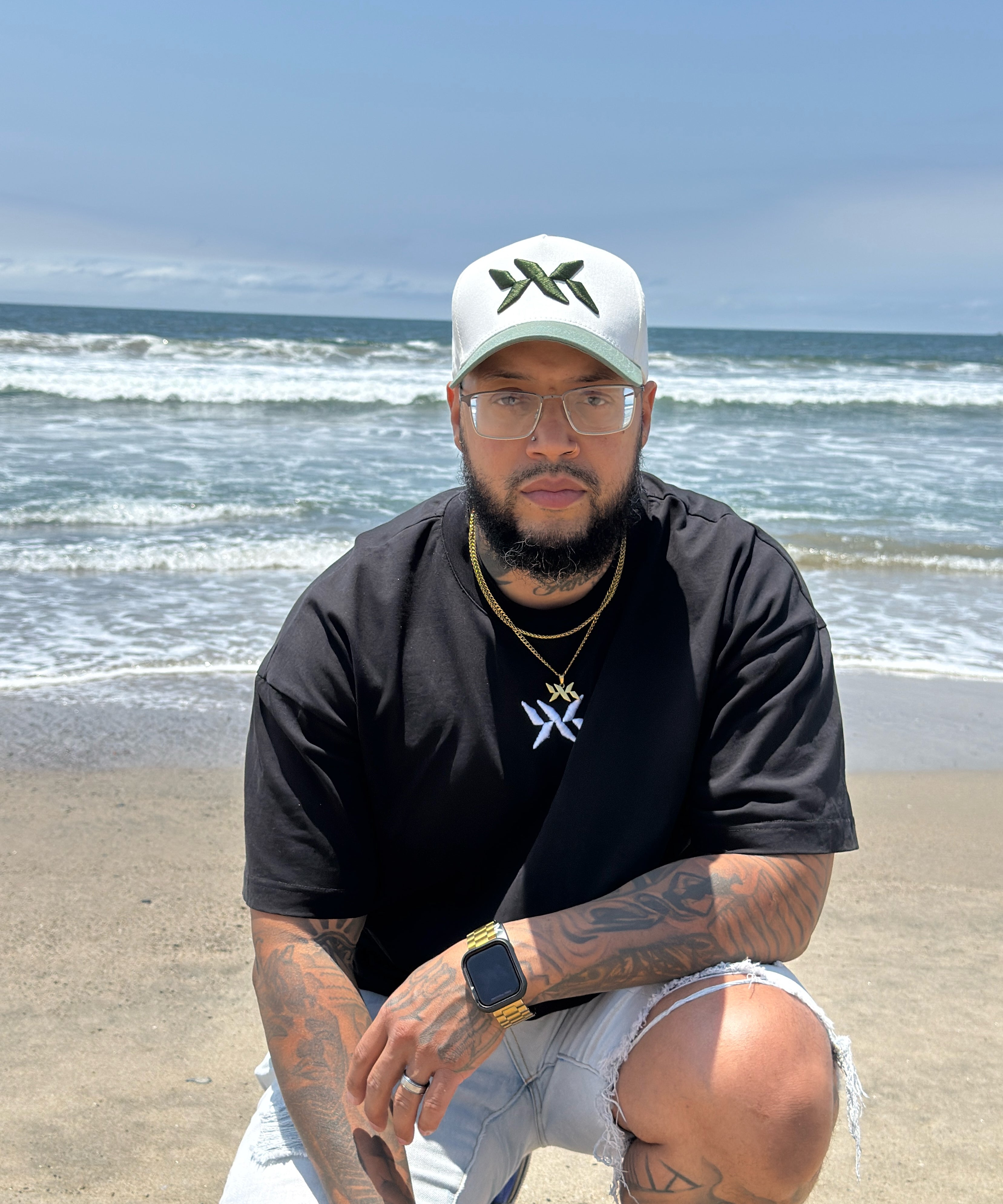 Model wearing IAC Lyfestyle DNA Strand snapback and tee at the beach, part of the DNA Core Duo bundle