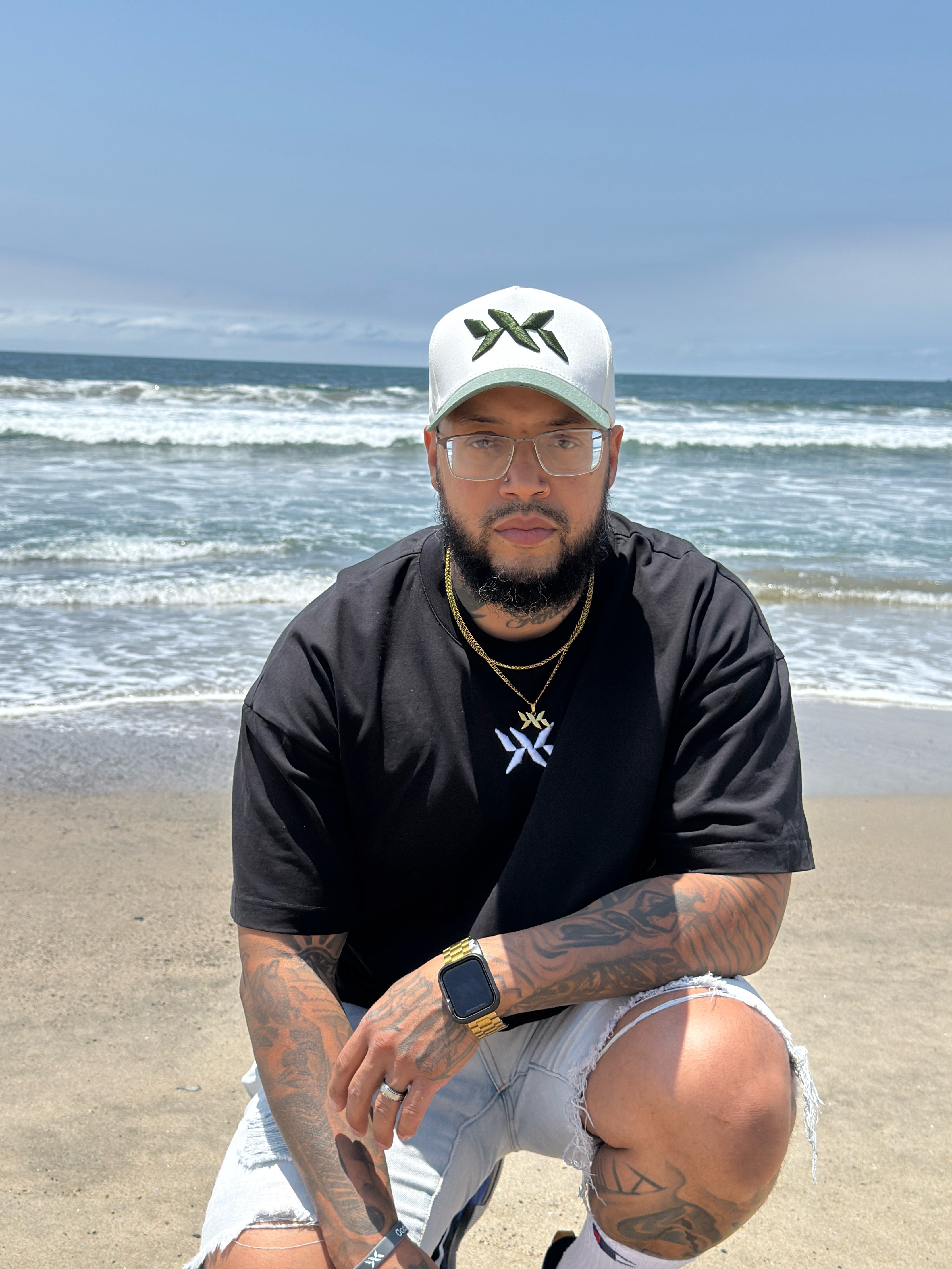 Model wearing IAC Lyfestyle DNA Strand snapback and tee at the beach, part of the DNA Core Duo bundle
