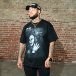 Model wearing the IAC Lyfestyle ‘We All Battle Demons No One Else Can See’ black oversized t-shirt, front view